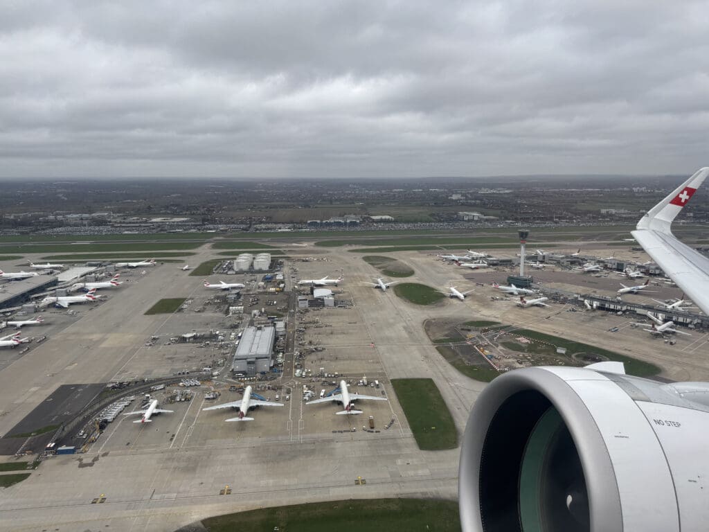 an aerial view of an airport with planes on the runway