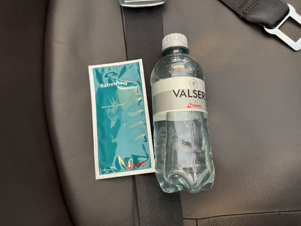 a bottle and a packet on a seat belt
