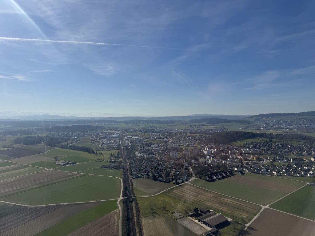 a landscape with a road and buildings