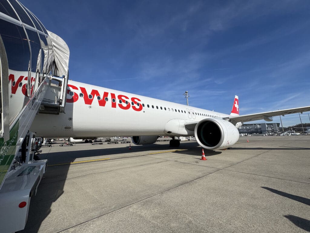 a white airplane with red writing on it