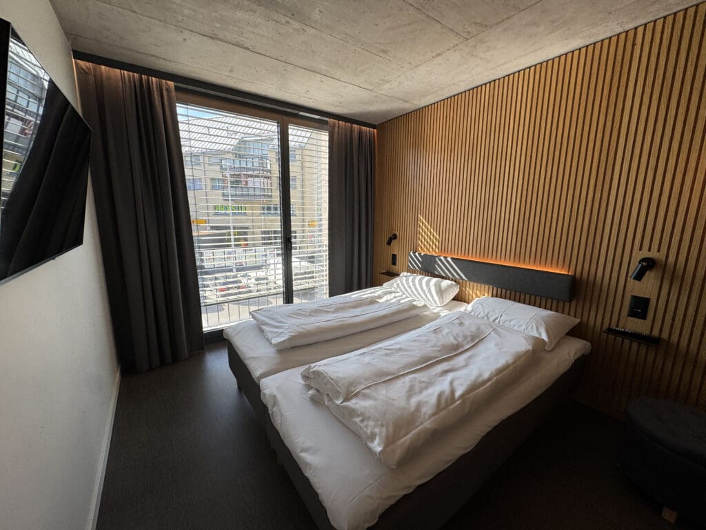 a room with two beds and a window