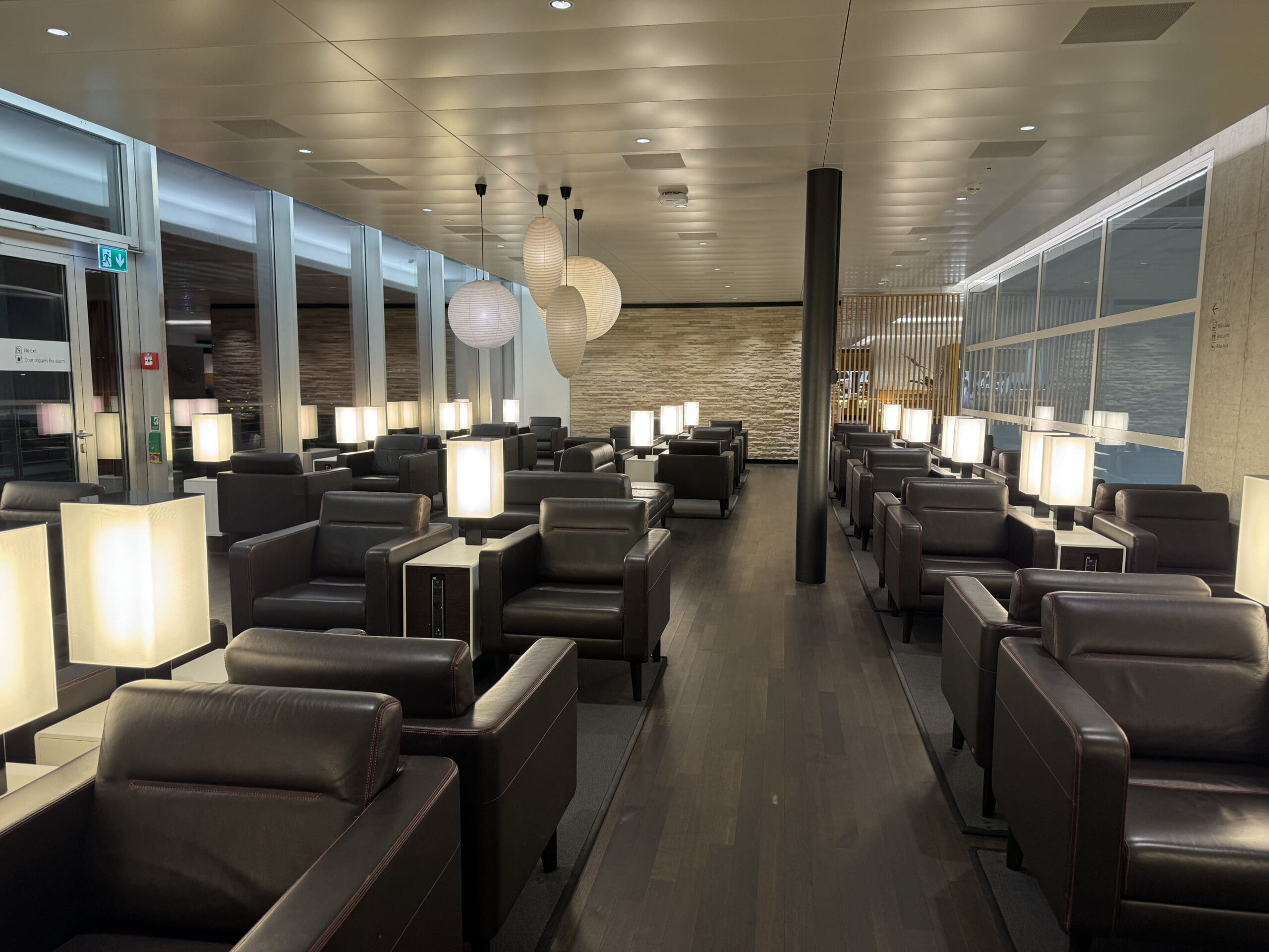 a room with chairs and lamps