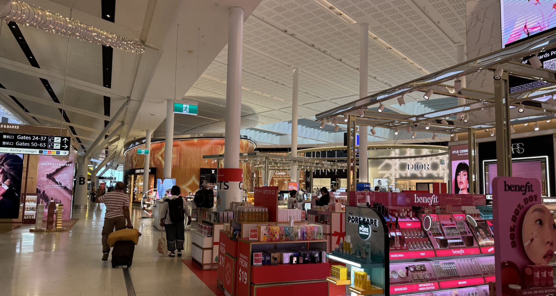 a large white building with many shelves and people walking