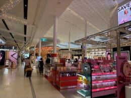 a large white building with many shelves and people walking