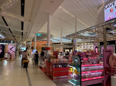 a large white building with many shelves and people walking