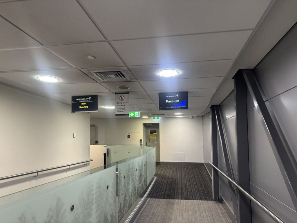 a hallway with a railing and signs
