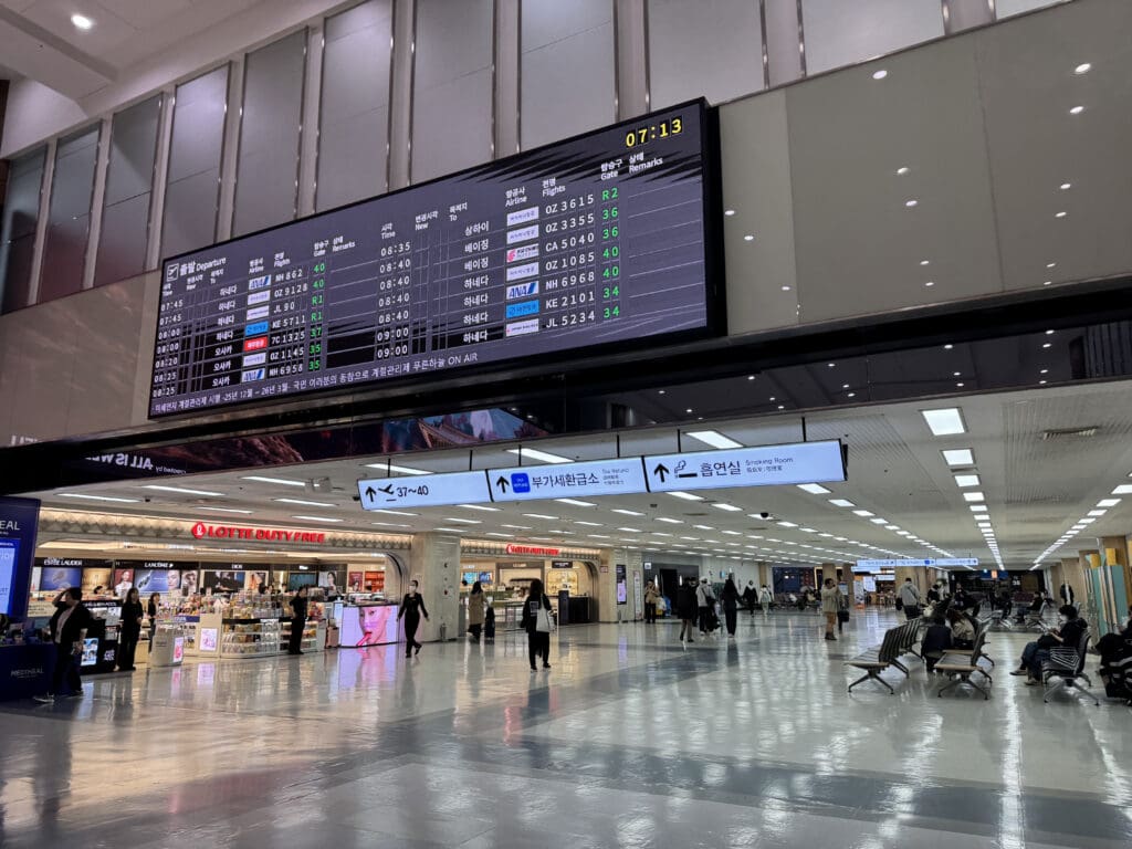 a large electronic screen in a large airport