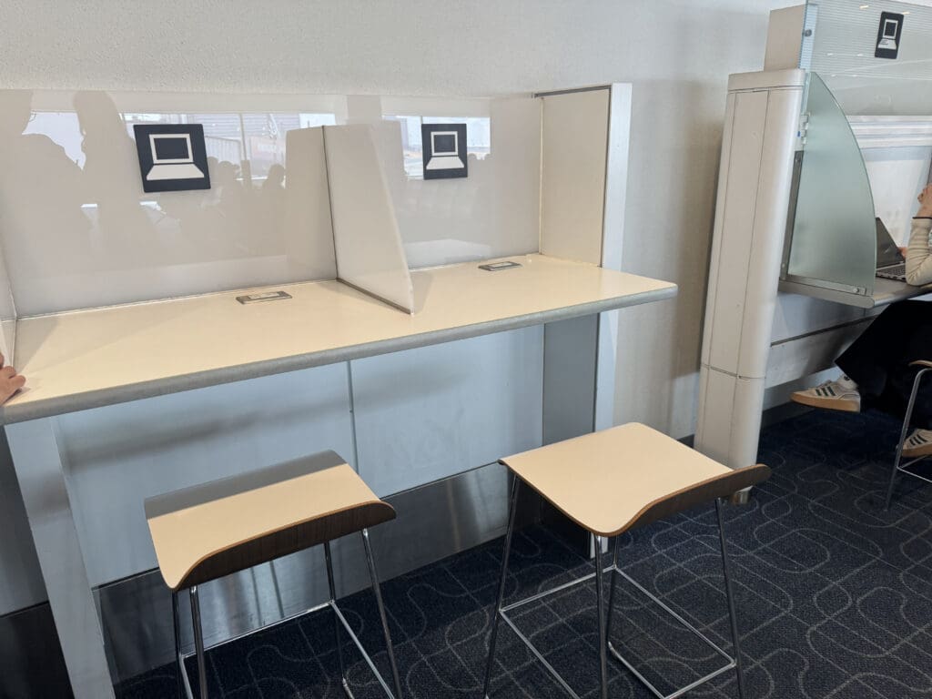 a white desk with two stools
