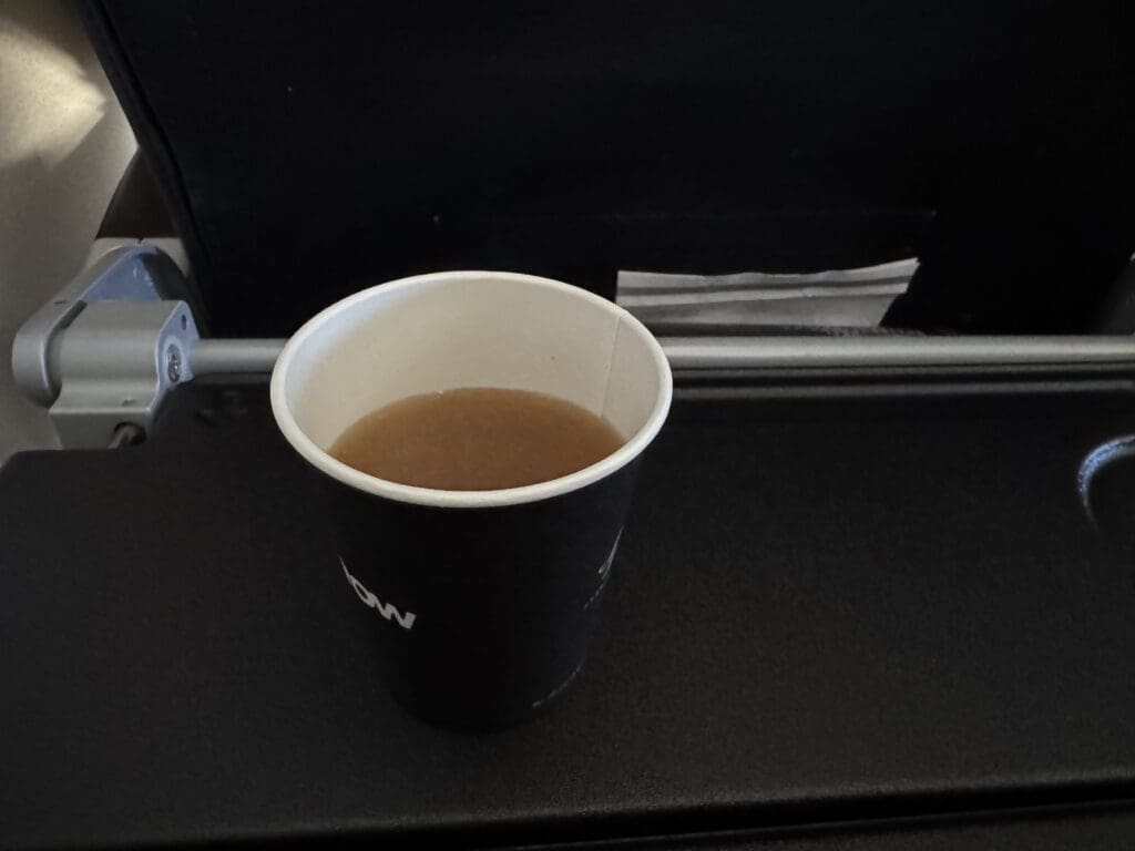 a cup of brown liquid on a black surface