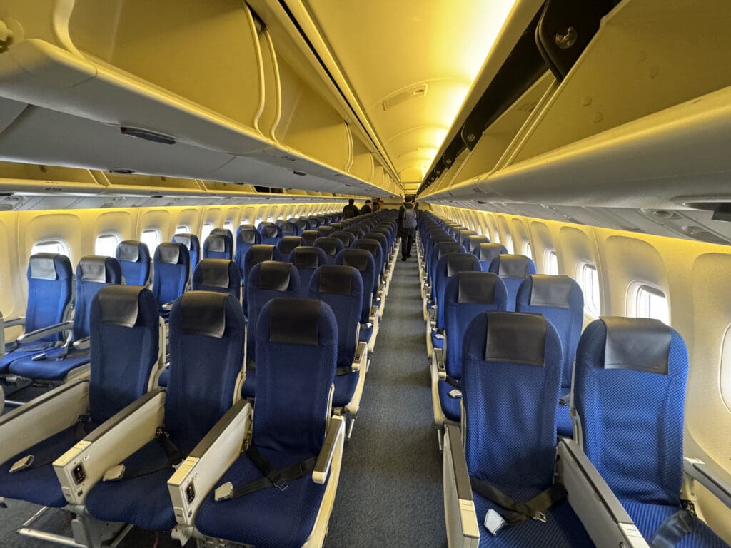a row of blue seats on an airplane