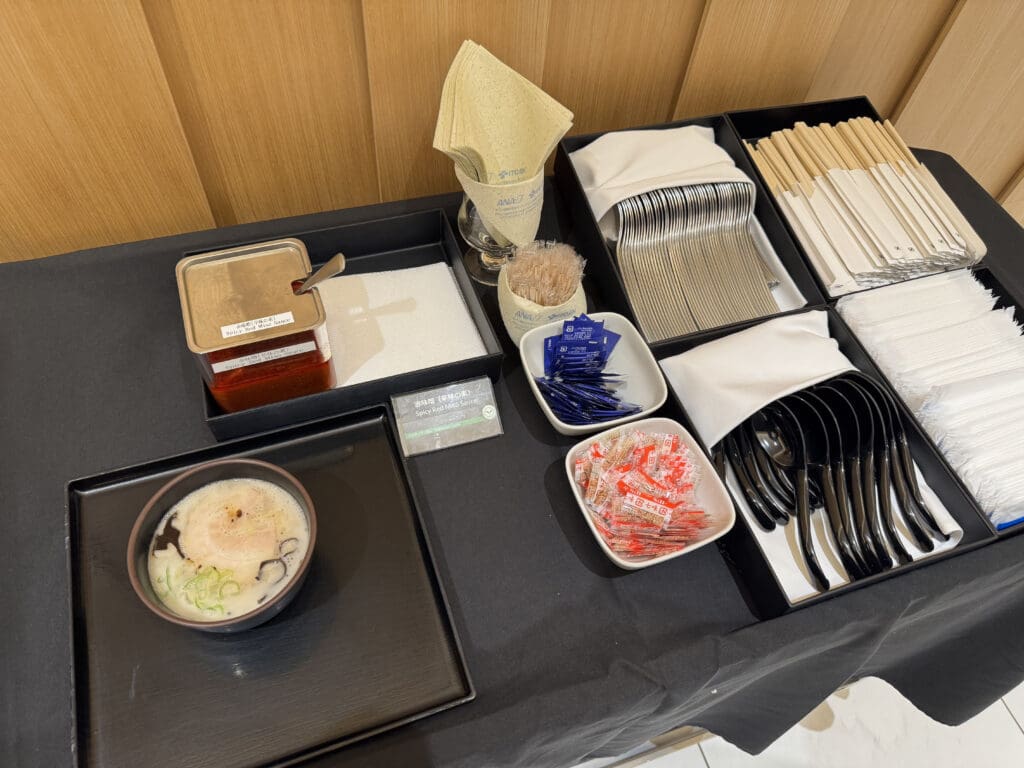 a table with a variety of utensils and bowls of food